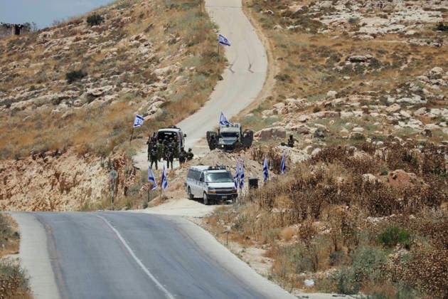 Protest Against Settlers in Dura Armed Israeli soldiers gather near military vehicles on a road in Jabal Tarousa near Dura, south of Hebron, in the occupied West Bank, on June 19, 2026. Palestinians held Friday prayers nearby to protest the establishment of a newly built Israeli settlement outpost and the seizure of land. Israeli forces later fired tear gas to suppress the gathering, allegedly causing several people, including journalists, to suffer from inhalation. Dura West Bank Palestinian Territories Copyright: xMosabxShawerx