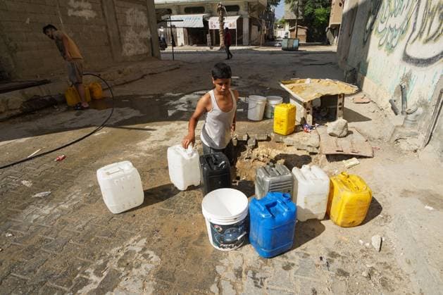 Residents Struggle to Access Drinking Water in Nuseirat Camp NUSEIRAT REFUGEE CAMP, CENTRAL GAZA STRIP JUNE 2026: Residents of Nuseirat refugee camp face increasing difficulties in obtaining drinking water and municipal water supplies amid ongoing shortages. Families dig makeshift pits in an effort to collect limited amounts of water to meet their daily needs. The scarcity of water continues to affect thousands of residents across the camp. NUSEIRAT, GAZA STRIP Palestine, State of Copyright: x xRamzixAbuxAmerx xJNAxPressx