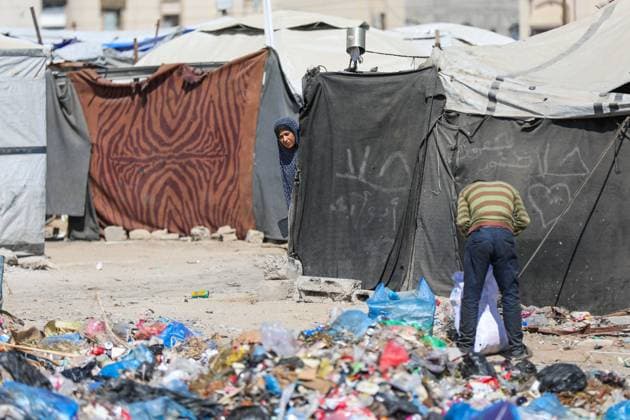 Displaced Families Endure Harsh Conditions in Bureij Refugee Camp GAZA STRIP JUNE 2026: Displaced Palestinians live in difficult conditions beside piles of accumulated waste in Bureij refugee camp. Children search through discarded materials in an attempt to find items that can help support their families amid worsening humanitarian conditions and limited access to basic necessities. BUREIJ PS Copyright: x xRamzixAbuxAmerx xJNAxPressx