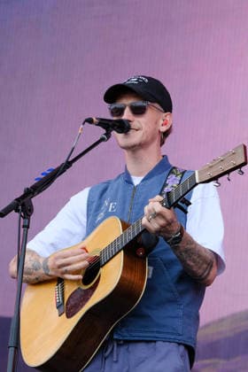June 20, 2026, Newport, United Kingdom: Scottish singer songwriter Nathan Evans born Nathan Alexander Evans, performing live on stage with The Saint PHNX Band at the Isle of Wight festival. He first gained fame in 2020 by posting videos of himself singing sea shanties on TikTok. In 2021, he released a version of the folk song Wellerman which peaked at the top of the UK Singles Chart. The Saint PHNX Band is currently Nathan Evans Lead vocals and acoustic guitar., Stevie Jukes Lead vocals, guitar, and bass, Alan Jukes Backing vocals, drums, and percussion Newport United Kingdom - ZUMAs197 20260620_aaa_s197_169 Copyright: xDawnxFletcher-Parkx