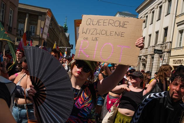June 20, 2026, Warsaw, Masovian Voivodeship, Poland: A person carries a sign that reads queer liberation or we riot during Warsaw s first ever radical Pride parade. Called Equality Parade - Queer Liberation March in Polish, the grassroots march was organized by a collective of radical LGBTQ+ activists as an anti-capitalist alternative to Warsaw s traditional Pride parade, which has recently become dominated by corporate sponsors. Warsaw Poland - ZUMAk204 20260620_zip_k204_005 Copyright: xRomanxKozielx