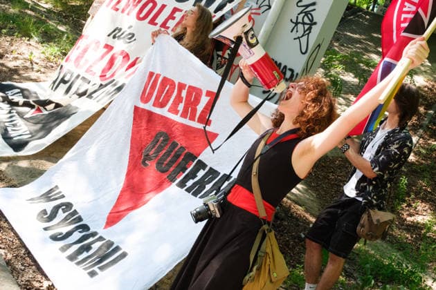 June 20, 2026, Warsaw, Masovian Voivodeship, Poland: An activist of Socialist Action yells into a megaphone as a banner that reads strike a blow against the system with your queerness is displayed during Warsaw s first ever radical Pride parade. Called Equality Parade - Queer Liberation March in Polish, the grassroots march was organized by a collective of radical LGBTQ+ activists as an anti-capitalist alternative to Warsaw s traditional Pride parade, which has recently become dominated by corporate sponsors. Warsaw Poland - ZUMAk204 20260620_zip_k204_022 Copyright: xRomanxKozielx