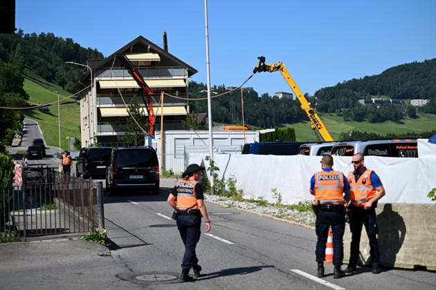 (260621) -- BURGENSTOCK, June 21, 2026 -- Police officers stand guard at the entrance to the road leading to a hotel complex in Burgenstock near Lucerne, Switzerland, June 20, 2026. Switzerland on Saturday said that it continues to provide a discreet and reliable setting to facilitate talks at the central Swiss resort of Burgenstock on the implementation of the Memorandum of Understanding between the United States and Iran. ) SWITZERLAND-BURGENSTOCK-U.S.-IRAN TALKS-RELIABLE SETTING LianxYi 