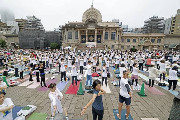 International Yoga Day People perform yoga during an event to mark International Yoga Day at Tsukiji Hongwanji temple in Tokyo on June 21, 2026.  A14AA0005619582P