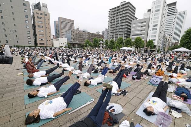 International Yoga Day People perform yoga during an event to mark International Yoga Day at Tsukiji Hongwanji temple in Tokyo on June 21, 2026.  A14AA0005619584P