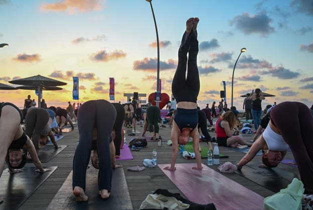 June 21, 2026, Tel-Aviv, Tel-Aviv, Israel: Hundreds of participants practice yoga during International Yoga Day at the Tel Aviv Port in Tel Aviv, joining an open public session featuring 108 Sun Salutations (Surya Namaskar), a traditional sequence symbolizing mindfulness, endurance and gratitude. Tel-Aviv Israel  - ZUMAp227 20260621_zip_p227_019 Copyright: xPaulinaxPatimerx