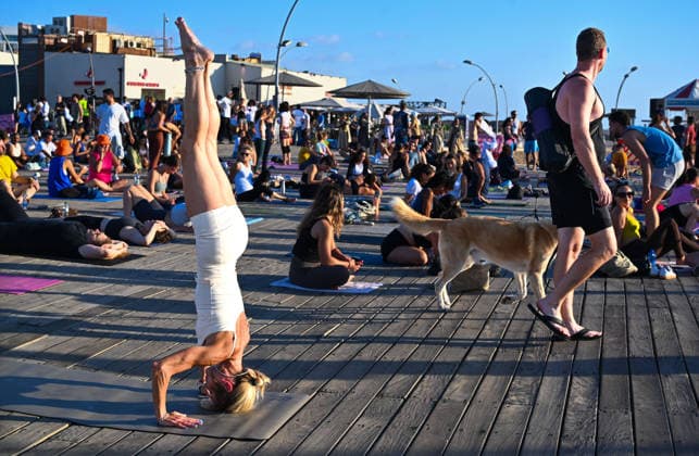 June 21, 2026, Tel-Aviv, Tel-Aviv, Israel: Hundreds of participants practice yoga during International Yoga Day at the Tel Aviv Port in Tel Aviv, joining an open public session featuring 108 Sun Salutations (Surya Namaskar), a traditional sequence symbolizing mindfulness, endurance and gratitude. Tel-Aviv Israel - ZUMAp227 20260621_zip_p227_005 Copyright: xPaulinaxPatimerx
