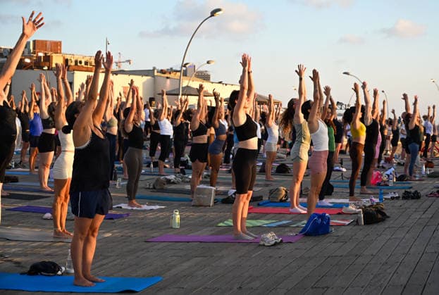 June 21, 2026, Tel-Aviv, Tel-Aviv, Israel: Hundreds of participants practice yoga during International Yoga Day at the Tel Aviv Port in Tel Aviv, joining an open public session featuring 108 Sun Salutations (Surya Namaskar), a traditional sequence symbolizing mindfulness, endurance and gratitude. Tel-Aviv Israel - ZUMAp227 20260621_zip_p227_011 Copyright: xPaulinaxPatimerx