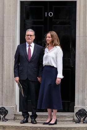 (260622) -- LONDON, June 22, 2026 () -- British Prime Minister Keir Starmer and his wife stand outside No. 10 Downing Street in London, Britain, on June 22, 2026. Starmer announced in a speech outside No. 10 Downing Street on Monday that he would resign as leader of the governing Labour Party and set out a timetable for his departure from office. Starmer said he would remain in office as prime minister until the Labour leadership contest is completed and would do everything I can to ensure an orderly handover of power. () BRITAIN-LONDON-PM-RESIGNATION Xinhua 