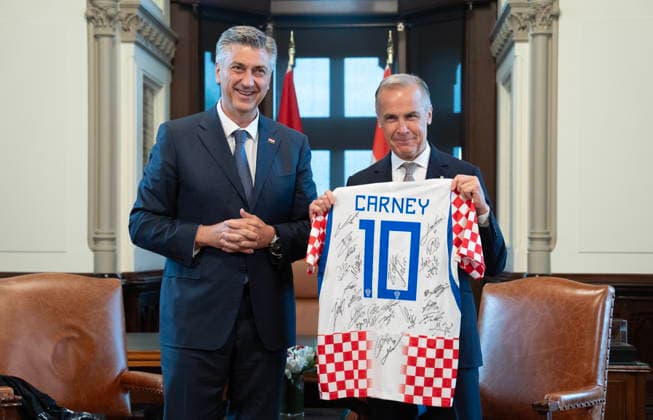 June 22, 2026, Ottawa, On, Canada: Prime Minister Mark Carney holds a soccer jersey signed by the Croatian team after Croatian Prime Minister Andrej Plenkovic presented it to him on Parliament Hill on Parliament Hill Monday, June 22, 2026. Ottawa Canada  - ZUMAc35_ 20260622_zaf_c35_003 Copyright: xAdrianxWyldx