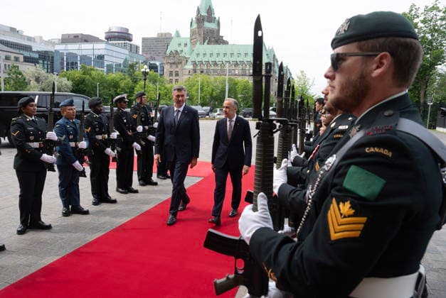 June 22, 2026, Ottawa, On, Canada: Prime Minister Mark Carney, centre right, walks with Croatian Prime Minister Andrej Plenkovic through an arrival guard outside the Mackenzie doors of West Block on Parliament Hill in Ottawa on Monday, June 22, 2026. Ottawa Canada  - ZUMAc35_ 20260622_zaf_c35_015 Copyright: xAdrianxWyldx