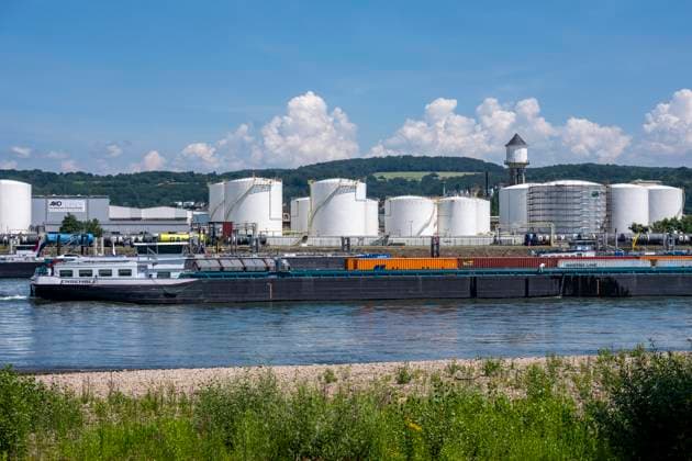 Frachtschiff auf dem Rhein, Höhe Bendorf, im Kreis Mayen-Koblenz, rechtsrheinisch, Tanklager der enport GmbH, 22 Großtanks, hauptschädlich für Kraftstoffe, Rheinland-Pfalz, Deutschland, Tanklager *** Cargo ship on the Rhine, near Bendorf, in the Mayen-Koblenz district, on the right bank of the Rhine, enport GmbH tank farm, 22 large tanks, primarily used for fuels, Rhineland-Palatinate, Germany, tank farm,detected_source_language