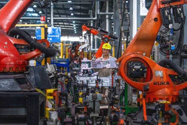 JINHUA, CHINA - JUNE 22: An employee works on the production line at the workshop of new energy vehicle components enterprise on June 22, 2026 in Jinhua, Zhejiang Province of China.  Copyright: xVCGx 111649698784