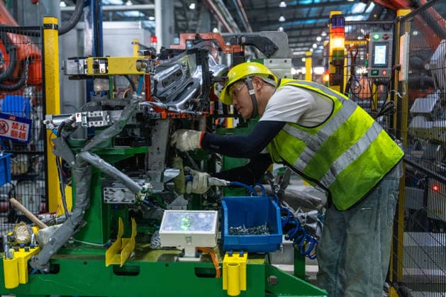 JINHUA, CHINA - JUNE 22: An employee works on the production line at the workshop of new energy vehicle components enterprise on June 22, 2026 in Jinhua, Zhejiang Province of China.  Copyright: xVCGx 111649698783