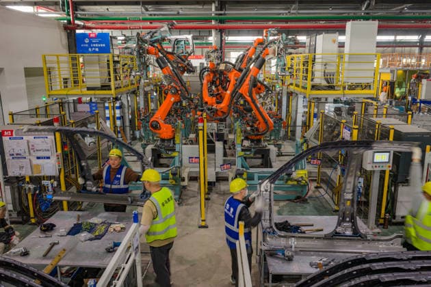 JINHUA, CHINA - JUNE 22: Employees work on the production line at the workshop of new energy vehicle components enterprise on June 22, 2026 in Jinhua, Zhejiang Province of China.  Copyright: xVCGx 111649698753
