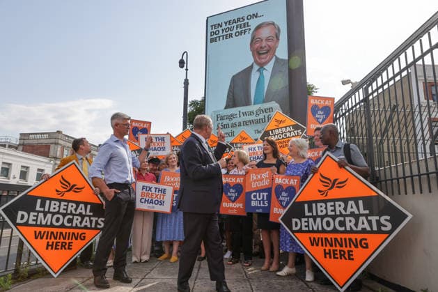 June 23, 2026, London, London, UK: London, UK. Liberal Democrat leader Ed Davey addresses party MPs and activists in front of a digital billboard in Fulham, London, during the launch of a new national campaign targeting Reform UK leader Nigel Farage and highlighting a Â£5 million gift he received, as the party marks the 10th anniversary of the Brexit referendum with the launch of its nationwide billboard campaign. London UK  - ZUMAl94_ 20260623_zaf_l94_024 Copyright: xDinendraxHariax