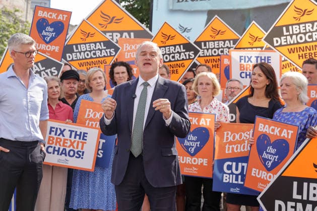 June 23, 2026, London, London, UK: London, UK. Liberal Democrat leader Ed Davey addresses party MPs and activists in front of a digital billboard in Fulham, London, during the launch of a new national campaign targeting Reform UK leader Nigel Farage and highlighting a Â£5 million gift he received, as the party marks the 10th anniversary of the Brexit referendum with the launch of its nationwide billboard campaign. London UK  - ZUMAl94_ 20260623_zaf_l94_027 Copyright: xDinendraxHariax