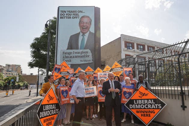 June 23, 2026, London, London, UK: London, UK. Liberal Democrat leader Ed Davey addresses party MPs and activists in front of a digital billboard in Fulham, London, during the launch of a new national campaign targeting Reform UK leader Nigel Farage and highlighting a Â£5 million gift he received, as the party marks the 10th anniversary of the Brexit referendum with the launch of its nationwide billboard campaign. London UK  - ZUMAl94_ 20260623_zaf_l94_028 Copyright: xDinendraxHariax