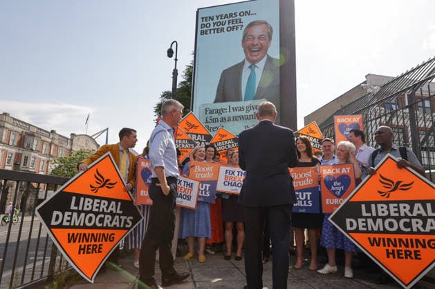 June 23, 2026, London, London, UK: London, UK. Liberal Democrat leader Ed Davey addresses party MPs and activists in front of a digital billboard in Fulham, London, during the launch of a new national campaign targeting Reform UK leader Nigel Farage and highlighting a Â£5 million gift he received, as the party marks the 10th anniversary of the Brexit referendum with the launch of its nationwide billboard campaign. London UK  - ZUMAl94_ 20260623_zaf_l94_029 Copyright: xDinendraxHariax