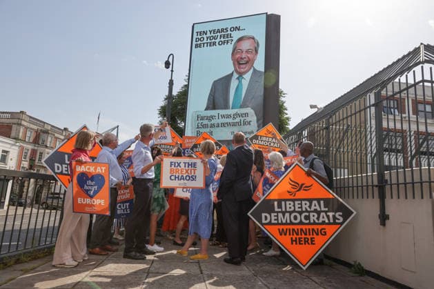June 23, 2026, London, London, UK: London, UK. Liberal Democrat leader Ed Davey addresses party MPs and activists in front of a digital billboard in Fulham, London, during the launch of a new national campaign targeting Reform UK leader Nigel Farage and highlighting a Â£5 million gift he received, as the party marks the 10th anniversary of the Brexit referendum with the launch of its nationwide billboard campaign. London UK  - ZUMAl94_ 20260623_zaf_l94_031 Copyright: xDinendraxHariax
