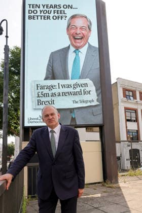 June 23, 2026, London, London, UK: London, UK. Liberal Democrat leader Ed Davey poses in front of a digital billboard in Fulham, London, during the launch of the Liberal Democrats new national campaign targeting Reform UK leader Nigel Farage and highlighting a Â£5 million gift he received, as the party marks the 10th anniversary of the Brexit referendum. London UK  - ZUMAl94_ 20260623_zaf_l94_035 Copyright: xDinendraxHariax