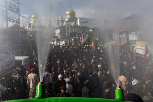 June 23, 2026, Srinagar, Jammu And Kashmir, India: Water sprays from sprinklers as Kashmiri Shia Muslims participate in a Muharram procession on the seventh day of Muharram in Rainawari, a neighbourhood in Srinagar, the summer capital of Indian Kashmir. Srinagar India - ZUMAf191 20260623_zip_f191_002 Copyright: xUmarxFarooqx