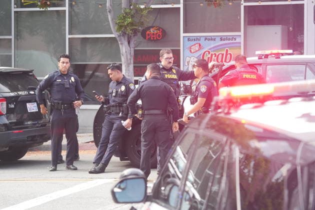 Officer shooting in San Diego, US - 23 Jun 2026 Police officers investigate at the scene after the shooting. San Diego police officers and firefighters respond to the Cedar Gateway apartment complex at Sixth Avenue and Cedar Street in the Cortez Hill neighborhood of downtown San Diego on Tuesday, June 23, 2026. Authorities said officers fatally shot a barricaded man after he allegedly threatened to kill his mother, threw household items from a fourth-floor apartment, and started a fire inside the unit. Residents were evacuated from the building as firefighters extinguished the blaze and investigators secured the scene. San Diego United States Copyright: xMichaelxHoxWaixLeex xSOPAxImagesx Michael Ho_5939