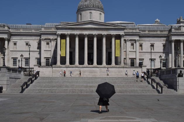 June 24, 2026, London, England, United Kingdom: A woman shelters under an umbrella from the scorching sun in Trafalgar Square as the Met Office issues an amber warning for extreme heat. London United Kingdom - ZUMAv130 20260624_zip_v130_009 Copyright: xVukxValcicx