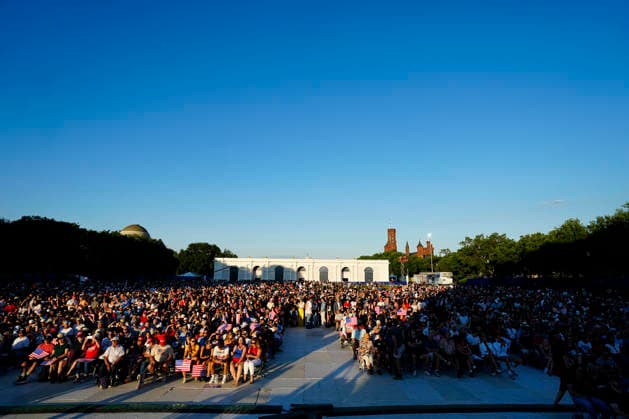 Attendees hold American flags before President Donald Trump speaks at a rally to kick off the 16-day Great American State Fair as part of Washington, D.C. s celebration of the nation s 250th birthday on the National Mall on Wednesday, June 24, 2026. The rally will include military flyovers, musical performances from Lee Greenwood and Christopher Macchio, and the U.S. Army Band, the U.S. Marine Band and Armed Forces choirs.  WAP20260624359 BONNIExCASH