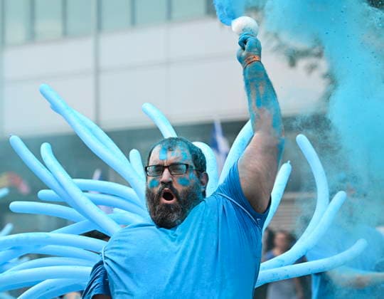 June 24, 2026, Montreal, Pq, Canada: A participant throws blue powder into the air during the Saint-Jean-Baptiste Day parade in Montreal, on Wednesday, June 24, 2026. Montreal Canada  - ZUMAc35_ 20260624_zaf_c35_176 Copyright: xGrahamxHughesx