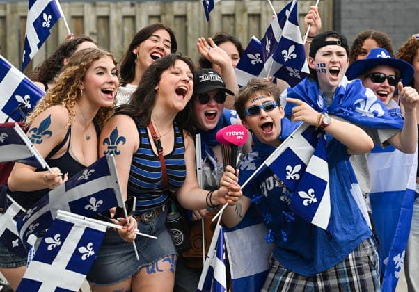 June 24, 2026, Montreal, Pq, Canada: Members of the crowd cheer as they watch the Saint-Jean-Baptiste Day parade in Montreal, on Wednesday, June 24, 2026. Montreal Canada  - ZUMAc35_ 20260624_zaf_c35_180 Copyright: xGrahamxHughesx