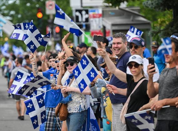 June 24, 2026, Montreal, Pq, Canada: Members of the crowd cheer as they watch the Saint-Jean-Baptiste Day parade in Montreal, on Wednesday, June 24, 2026. Montreal Canada  - ZUMAc35_ 20260624_zaf_c35_181 Copyright: xGrahamxHughesx