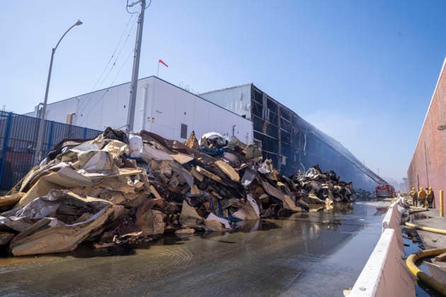 June 24, 2026, Los Angeles, California, USA: A pile of fire-damaged materials lines the outside of a warehouse as firefighters continue working at the scene of a warehouse fire in the Boyle Heights neighborhood of Los Angeles on Wednesday, June 24, 2026. Los Angeles USA - ZUMAc68_ 20260624_zaf_c68_004 Copyright: xRingoxChiux