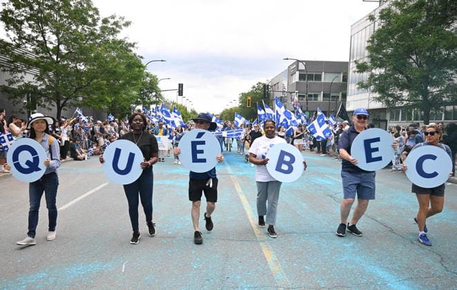 June 24, 2026, Montreal, Pq, Canada: Participants hold up letters spelling the word Quebec during the Saint-Jean-Baptiste Day parade in Montreal, on Wednesday, June 24, 2026. Montreal Canada  - ZUMAc35_ 20260624_zaf_c35_182 Copyright: xGrahamxHughesx