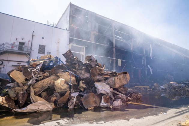 June 24, 2026, Los Angeles, California, USA: A pile of fire-damaged materials lines the outside of a warehouse as firefighters continue working at the scene of a warehouse fire in the Boyle Heights neighborhood of Los Angeles on Wednesday, June 24, 2026. Los Angeles USA - ZUMAc68_ 20260624_zaf_c68_007 Copyright: xRingoxChiux