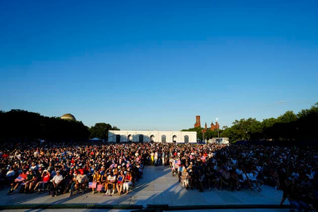 Attendees hold American flags before President Donald Trump speaks at a rally to kick off the 16-day Great American State Fair as part of Washington, D.C. s celebration of the nation s 250th birthday on the National Mall on Wednesday, June 24, 2026. The rally will include military flyovers, musical performances from Lee Greenwood and Christopher Macchio, and the U.S. Army Band, the U.S. Marine Band and Armed Forces choirs.  WAP20260624359112 BONNIExCASH