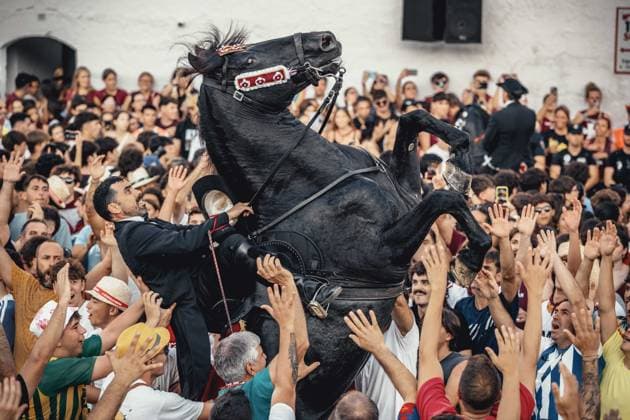 June 24, 2026, Ciutadella, Menorca Balearic Islands, Spain: A caixer (horse rider) rears up on his horse surrounded by a cheering crowd during the cargol prior to the Jocs des Pla (medieval tournament) during the traditional Sant Joan (Saint John) festival in Ciutadella de Menorca Ciutadella Spain - ZUMAo105 20260624_fap_o105_018 Copyright: xMatthiasxOesterlex
