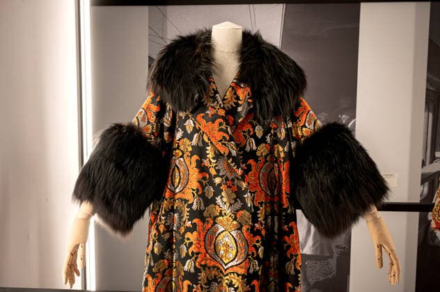 Exhibition: Fashion in Light 1955 1975 ROME, ITALY - JUNE 25: Evening-gala Overcoat, Sartoria Zecca, 1960, in silk damask rich ornamental motifs in shades of orange, gold, silver and black.The wide. and flared silhouette, is enriched by a sumptuous collar and wide cuffs in black fox. Formerly owned by Silvana Mangano, it was recently worm by Angelina Jolie in the movie Maria (Paplo Larrain, 2024), during the Exhibition Fashion in Light 1955 1975, Rome: between glamour and industrial innovation, featuring cinema, style, the great fashion designers, timeless brands, and the stars of the silver screen and haute couture, at the Capitoline Museums, Centrale Montemartini on June 25, 2026 in Rome, Italy. Rome Italy Copyright: xStefanoxMontesix