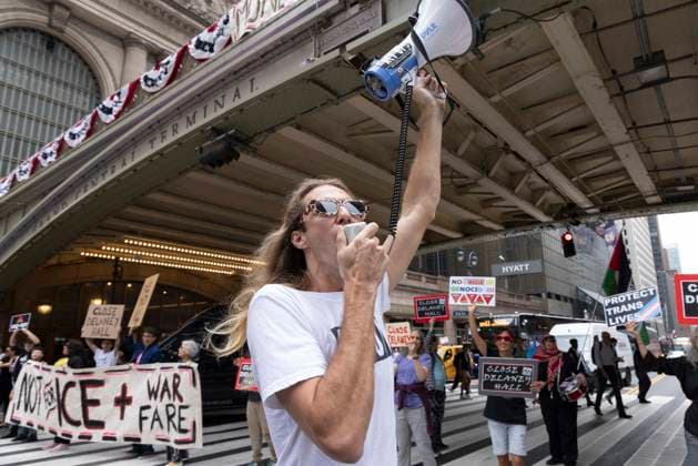 June 26, 2026, New York, New York, USA: Members of ACT UP New York begin Pride weekend with an act of civil disobedience blockading traffic during the morning rush hour on 42nd Street outside Grand Central Station stating solidarity with striking Delaney Hall immigrant detainees and denouncing Trump administration cuts to AIDS funding and healthcare. After traffic is at a standstill for approximately 40 minutes, NYPD arrests demonstrators. The protest banner is Ã¢â‚¬ËœMoney for AIDS and Healthcare Not for ICE and Warfare. Demonstrators defend New YorkÃ¢â‚¬â ¢s sanctuary city status as an ICE surge is promised and protest funding cuts to AIDS Drug Assistance Programs (ADAP,) The U.S. PresidentÃ¢â‚¬â ¢s Emergency Plan for AIDS Relief (PEPFAR - ZUMAr174 20260626_znp_r174_006 Copyright: xGinaxMxRandazzox