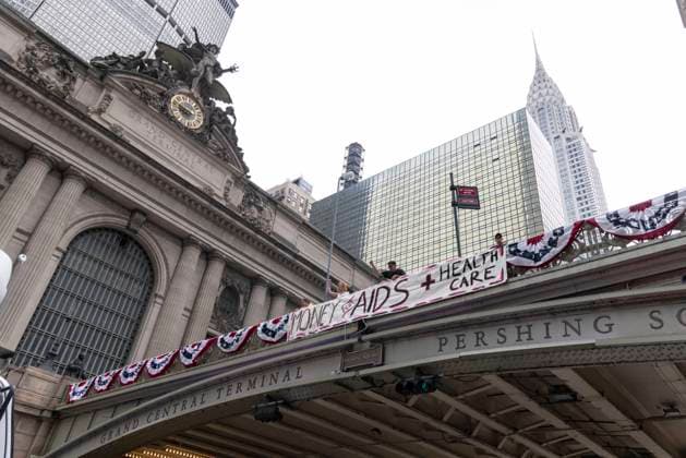 June 26, 2026, New York, New York, USA: Members of ACT UP New York begin Pride weekend with an act of civil disobedience blockading traffic during the morning rush hour on 42nd Street outside Grand Central Station stating solidarity with striking Delaney Hall immigrant detainees and denouncing Trump administration cuts to AIDS funding and healthcare. After traffic is at a standstill for approximately 40 minutes, NYPD arrests demonstrators. The protest banner is Ã¢â‚¬ËœMoney for AIDS and Healthcare Not for ICE and Warfare. Demonstrators defend New YorkÃ¢â‚¬â ¢s sanctuary city status as an ICE surge is promised and protest funding cuts to AIDS Drug Assistance Programs (ADAP,) The U.S. PresidentÃ¢â‚¬â ¢s Emergency Plan for AIDS Relief (PEPFAR - ZUMAr174 20260626_znp_r174_005 Copyright: xGinaxMxRandazzox