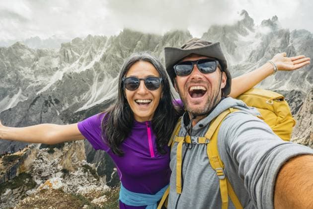 Fröhliches, glückliches Paar von Wanderfreunden, die ein Selfie am Aussichtspunkt Cadini di Misurina machen. Millennial Mädchen genießt Tagesausflug im Sommer und lacht gemeinsam in die Kamera Millennial Reisende Cheerful happy couple of hikers friends taking selfie on Cadini di Misurina viewpoint. Millennial guy girl enjoying summertime day out trip laughing at camera together - Millennial travelers Copyright: imageBROKER EvaldasxMikoliunas ibxemi18154109.jpg ,model released, Symbolfoto ,property released