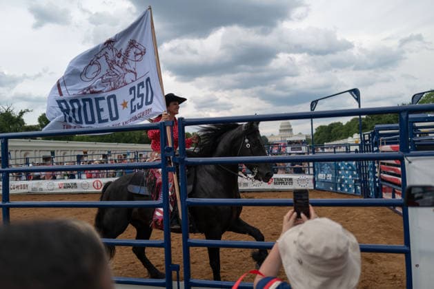 June 26, 2026, Washington, District Of Columbia, USA: A cowgirl carries a flag at a rodeo during the Great American State Fair on the National Mall in Washington, D.C. on June 26, 2026. Rodeo 250, produced by Cervi Rodeo Company, is one of numerous events during the 16-day fair, celebrating the 250th anniversary of the United States of America. Washington USA - ZUMAd227 20260626_znp_d227_014 Copyright: xBryanxDozierx