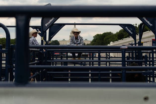 June 26, 2026, Washington, District Of Columbia, USA: A cowboy rests on a fence before a rodeo during the Great American State Fair on the National Mall in Washington, D.C. on June 26, 2026. Rodeo 250, produced by Cervi Rodeo Company, is one of numerous events during the 16-day fair, celebrating the 250th anniversary of the United States of America. Washington USA - ZUMAd227 20260626_znp_d227_011 Copyright: xBryanxDozierx
