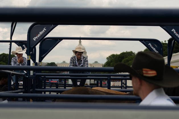 June 26, 2026, Washington, District Of Columbia, USA: A cowboy rests on a fence before a rodeo during the Great American State Fair on the National Mall in Washington, D.C. on June 26, 2026. Rodeo 250, produced by Cervi Rodeo Company, is one of numerous events during the 16-day fair, celebrating the 250th anniversary of the United States of America. Washington USA - ZUMAd227 20260626_znp_d227_012 Copyright: xBryanxDozierx