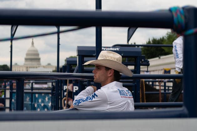 June 26, 2026, Washington, District Of Columbia, USA: A cowboy rests on a fence before a rodeo during the Great American State Fair on the National Mall in Washington, D.C. on June 26, 2026. Rodeo 250, produced by Cervi Rodeo Company, is one of numerous events during the 16-day fair, celebrating the 250th anniversary of the United States of America. Washington USA - ZUMAd227 20260626_znp_d227_013 Copyright: xBryanxDozierx
