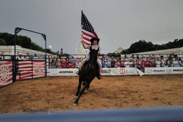 June 26, 2026, Washington, District Of Columbia, USA: A woman carries an American flag while riding a horse at a rodeo during the Great American State Fair on the National Mall in Washington, D.C. on June 26, 2026. Rodeo 250, produced by Cervi Rodeo Company, is one of numerous events during the 16-day fair, celebrating the 250th anniversary of the United States of America. Washington USA - ZUMAd227 20260626_znp_d227_055 Copyright: xBryanxDozierx
