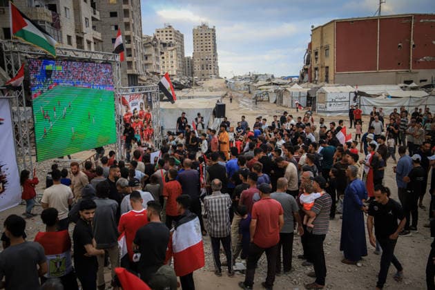 Palestinians watch the Iran-Egypt match on giant screens set up amid the rubble GAZA CITY, GAZA, PALESTINE - JUNE 27: Palestinians holding flags gather to watch the 2026 FIFA World Cup First Stage Group G match between Egypt and Iran on a giant screen set up among the rubble of destroyed buildings despite Israel s ongoing attacks in Gaza City, Gaza, Palestine, on June 27, 2026. Abdalhkem Abu Riash Anadolu Gaza City Gaza. Editorial use only. Please get in touch for any other usage.  Copyright: x2026xAnadoluxAbdalhkemxAbuxRiashx