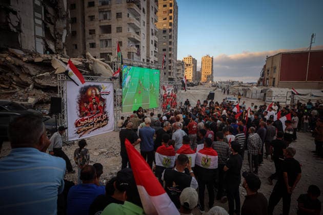 Palestinians watch the Iran-Egypt match on giant screens set up amid the rubble GAZA CITY, GAZA, PALESTINE - JUNE 27: Palestinians holding flags gather to watch the 2026 FIFA World Cup First Stage Group G match between Egypt and Iran on a giant screen set up among the rubble of destroyed buildings despite Israel s ongoing attacks in Gaza City, Gaza, Palestine, on June 27, 2026. Abdalhkem Abu Riash Anadolu Gaza City Gaza. Editorial use only. Please get in touch for any other usage.  Copyright: x2026xAnadoluxAbdalhkemxAbuxRiashx