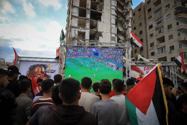 Palestinians watch the Iran-Egypt match on giant screens set up amid the rubble GAZA CITY, GAZA, PALESTINE - JUNE 27: Palestinians holding flags gather to watch the 2026 FIFA World Cup First Stage Group G match between Egypt and Iran on a giant screen set up among the rubble of destroyed buildings despite Israel s ongoing attacks in Gaza City, Gaza, Palestine, on June 27, 2026. Abdalhkem Abu Riash Anadolu Gaza City Gaza. Editorial use only. Please get in touch for any other usage.  Copyright: x2026xAnadoluxAbdalhkemxAbuxRiashx
