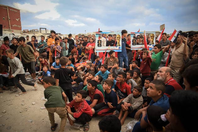 Palestinians watch the Iran-Egypt match on giant screens set up amid the rubble GAZA CITY, GAZA, PALESTINE - JUNE 27: Palestinians holding flags gather to watch the 2026 FIFA World Cup First Stage Group G match between Egypt and Iran on a giant screen set up among the rubble of destroyed buildings despite Israel s ongoing attacks in Gaza City, Gaza, Palestine, on June 27, 2026. Abdalhkem Abu Riash Anadolu Gaza City Gaza. Editorial use only. Please get in touch for any other usage.  Copyright: x2026xAnadoluxAbdalhkemxAbuxRiashx